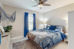 a bedroom with a bed and a ceiling fan at Dreaming on the Canal in Port Charlotte
