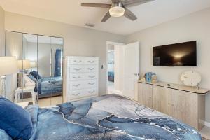 a bedroom with a bed and a ceiling fan at Dreaming on the Canal in Port Charlotte