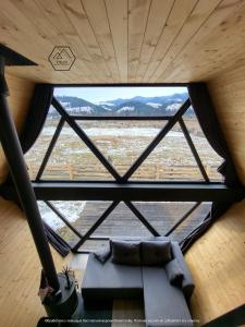 a large window in a room with a couch at Vulyk Guesthouse in Verkhovyna +31 photos