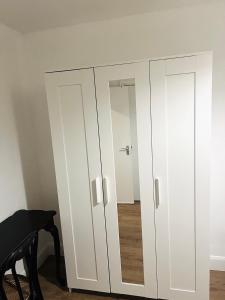 a white cabinet with two doors in a room at Double bed Room for Couple tidy room Room 4 in London