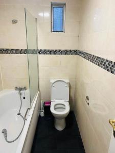 a bathroom with a toilet and a tub and a shower at Double bed Room in London