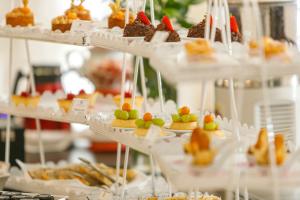 a display of desserts and pastries on white plates at Carballo Hotel & Spa in Campos do Jordão