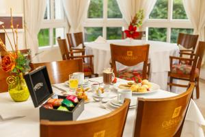a dining room with a table with a plate of food at Carballo Hotel & Spa in Campos do Jordão