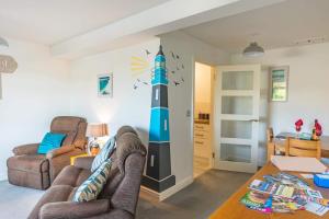 a living room with a lighthouse mural on the wall at The Portwey Pearl in Rodwell