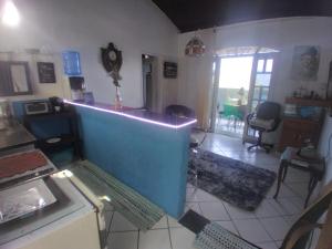 a living room with a blue wall and a table at Beleza de Angra Apartamento Aconchegante in Angra dos Reis