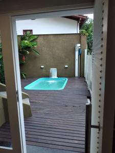 a hot tub sitting on a wooden deck at Loft em Caldas da Imperatriz - SC in Santo Amaro da Imperatriz