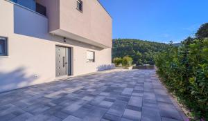 a driveway leading to a building with a door at Luxury Villa Oriolus, heated pool, sauna, Split in Srinjine