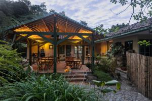 a house with a patio with tables and chairs at Sazagua Cocora Reserva Natural in Salento