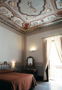 a bedroom with a coffered ceiling and a bed and a window at Hotel Palazzo D'Erchia in Conversano