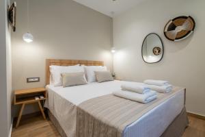 a bedroom with a large bed with towels on it at Kondias Experience in Kondiás