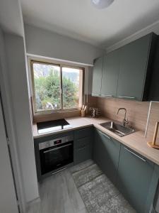 a small kitchen with a sink and a window at Studio cosy de charme ! in Beaulieu-sur-Mer +12 photos