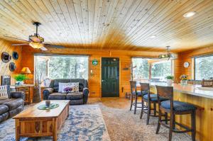 a living room with a table and chairs and a kitchen at Duck Creek Village Cozy Cabin Near Fishing and ATV in Duck Creek Village