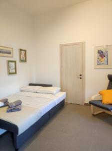 a bedroom with two beds and a door at Nicola's House in Myrina