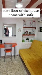 a woman taking a picture of a bedroom with a bed and a desk at Alora Sweet Home in Alora