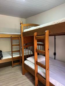 two bunk beds in a small room with at Social Hostel Café e Bar in Curitiba