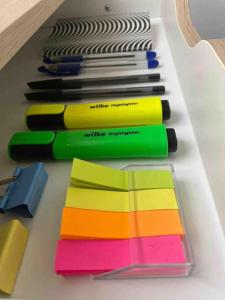 a row of different colored markers on a table at Studio Apartment - London in London