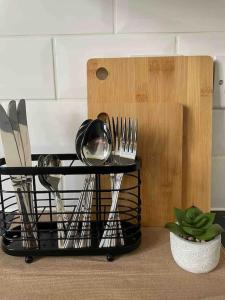 a black serving cart with utensils on it at Studio Apartment - London in London