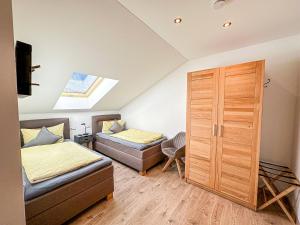 a bedroom with two beds and a closet at Ferienwohnungen Gastager Hof in Ruhpolding