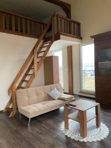 a living room with a couch and a staircase at Penzión IMRICH CAR in Prešov