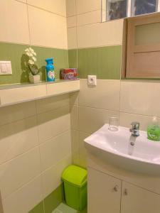 a bathroom with a sink and a green stool at Penzión IMRICH CAR in Prešov