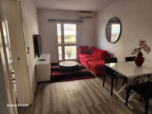 a living room with a red couch and a table at Appartement Sao Filipe in Praia