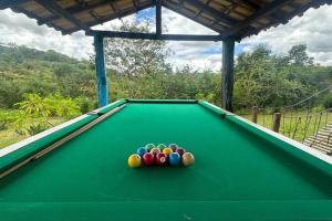 a pool table with balls on top of it at Sítio Pousadinhas do Lago in Almeida
