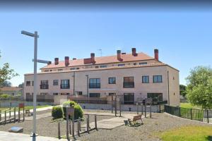 a large white building with a lot of windows at Piso ESPAZ in Isla de Arosa
