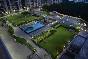 een luchtzicht op een tuin met een zwembad bij Niva Stays Riverside 1 in Kharadi