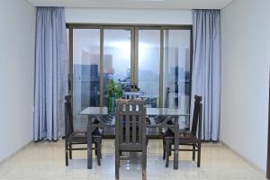 a dining room with a table and chairs and a window at Niva Stays Riverside 1 in Kharadi