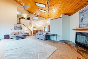 a living room with two couches and a fireplace at Pebble Beach Bliss in Crescent City