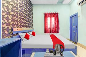a bedroom with a bed with a red curtain at Flagship Hotel Royal in Rānchī