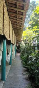 a hallway of a building with awning and plants at 4eTal Trancoso in Trancoso