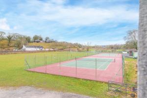 a tennis court in the middle of a field at Romantic getaway in this stylish studio with views and free parking in Burneside
