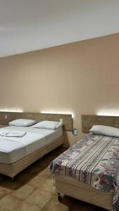 twee bedden naast elkaar in een kamer bij HOTEL AMADO in Aracaju