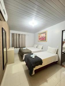 Habitación de hotel con 2 camas y ventana en POUSADA CABANA DO PARQUE, en Mateiros