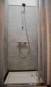 a shower with a shower head in a bathroom at Studio Duquesne 1/2 pers in Nantes