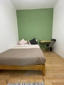 a bedroom with a bed and a table with a desk at UCO Roma in Mexico City