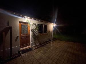 a house with a wooden door at night at Dar Kareem in Villeparisis