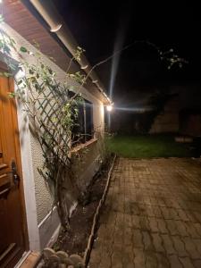 a house with a fence next to a building at night at Dar Kareem in Villeparisis +1 photo