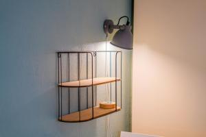 a shelf on the wall with a candle on it at Stylish Private Studio Close to City in Amsterdam +16 photos