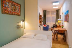a bedroom with a bed and a dining room at Stylish Private Studio Close to City in Amsterdam