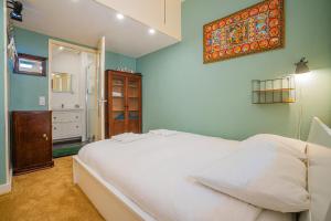 a bedroom with a large white bed in a room at Stylish Private Studio Close to City in Amsterdam