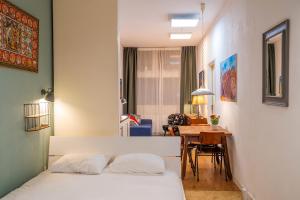 a bedroom with a bed and a dining room at Stylish Private Studio Close to City in Amsterdam