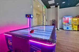 a bowling alley with a purple in a room at Regal Oaks Resort Vacation Townhomes by IDILIQ in Orlando