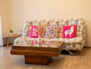 a living room with a couch with pillows and a table at Ma-Bebe Spa and Play Suite - Thermal Jacuzzi - Free Tickets to Ostrich Farm in Pchelin