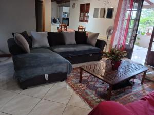 a living room with a couch and a table at La Villa Belle in La Trinité