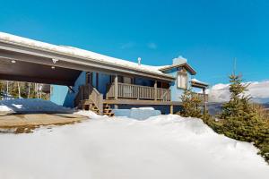 a blue house with snow in front of it at Le Chalet Bleu in Angel Fire