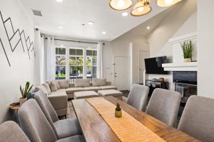 a living room with a couch and a table and chairs at Olivia Oasis in Oxnard