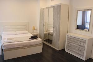 a bedroom with a bed and a large mirror at Apartment Sofi in Valencia