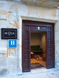 a door to a building with a couch behind it at M&UGA Hotela in Elorrio